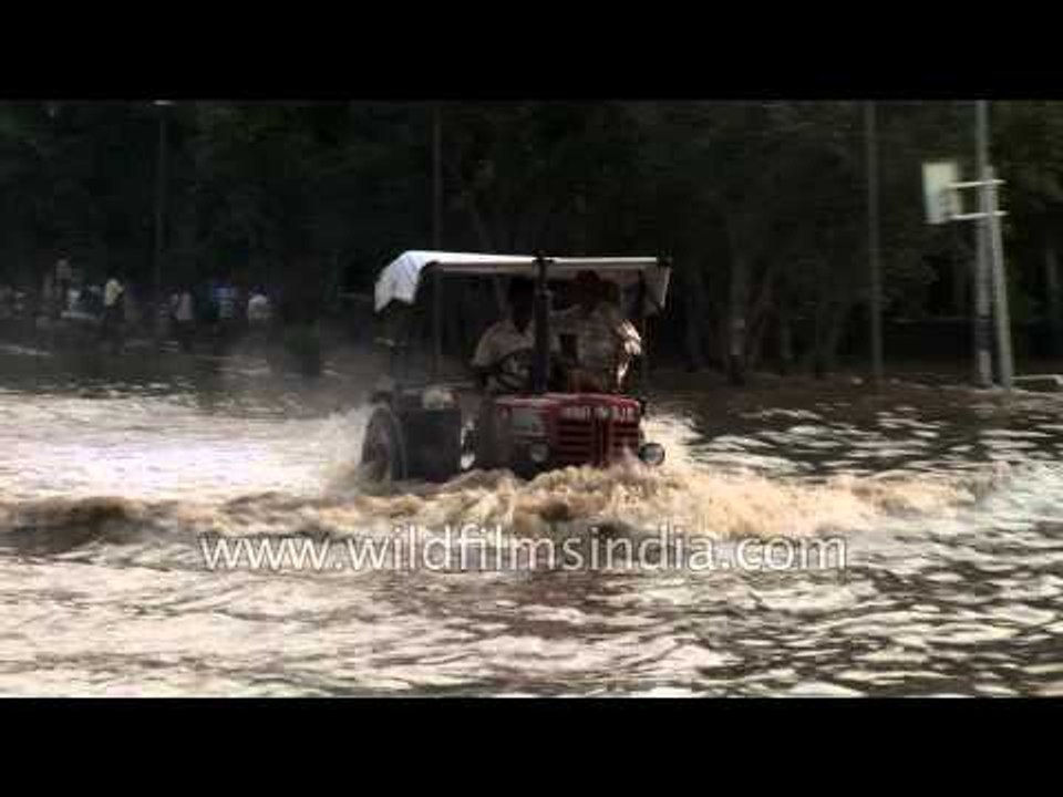 Vehicles negotiate flooded roads as heavy rain lashed Delhi