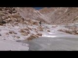 Slip sliding over a frozen stream in wintery Ladakh