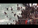 No sooner does the Ganges enter the Indian plains than thousands jump in for a holy dip!