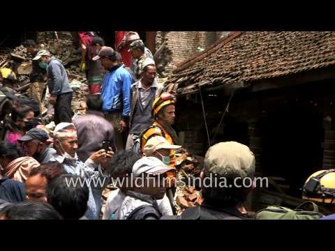 Residents look at collapsed houses in Bhaktapur, Nepal