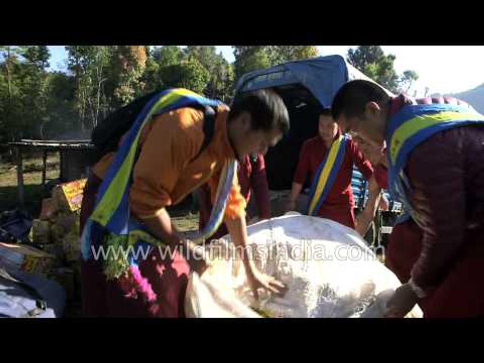 Relief goods unloaded by monks at Thulo Dhading village - Nepal