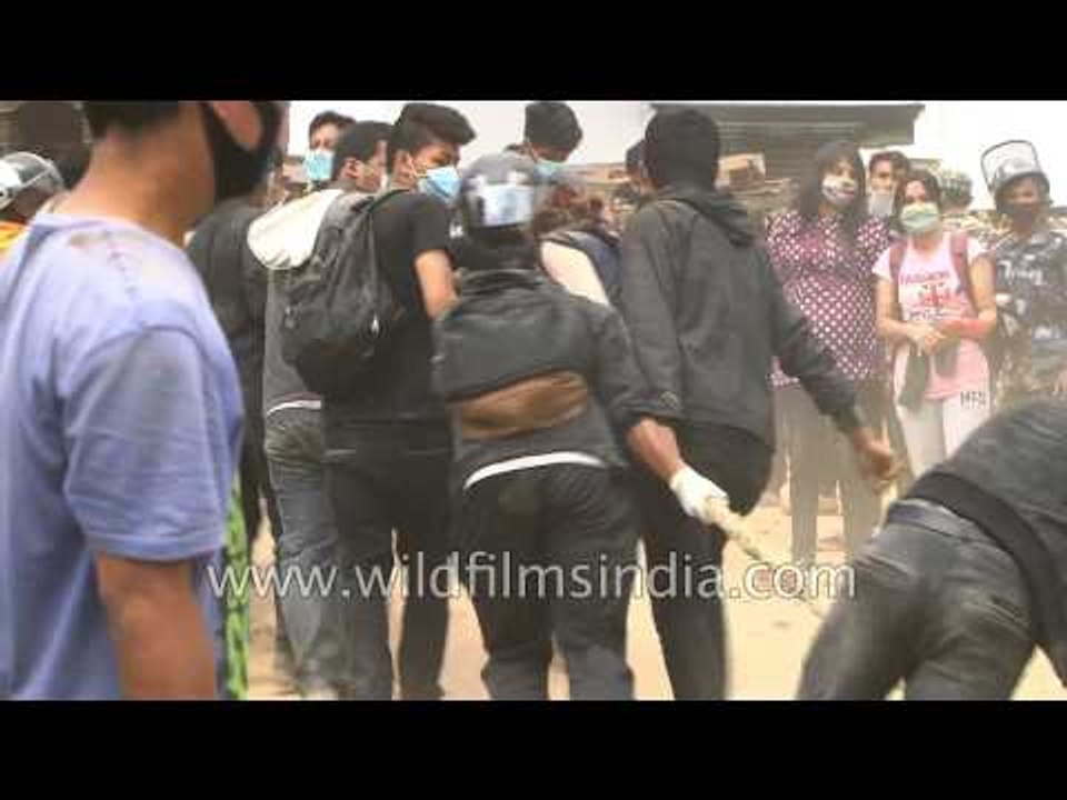 People clear the ruin of a collapsed temple at Basantapur Durbar Square
