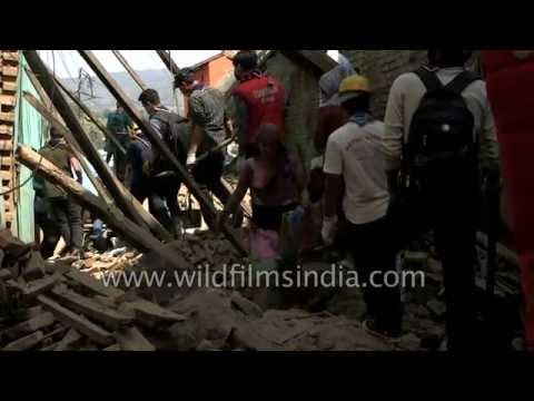 Earthquake victims search for belongings at collapsed house in Sankhu, Nepal