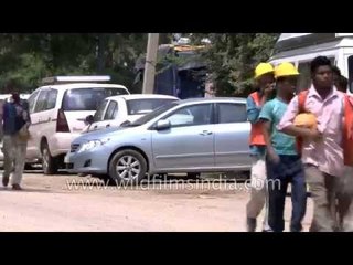 Construction workers head to work near Safdarjung Hospital in South Delhi
