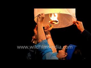 People launching paper hot air balloons in Rishikesh