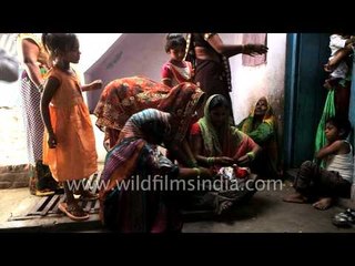 Devotee spoon feeding baby Ganesha