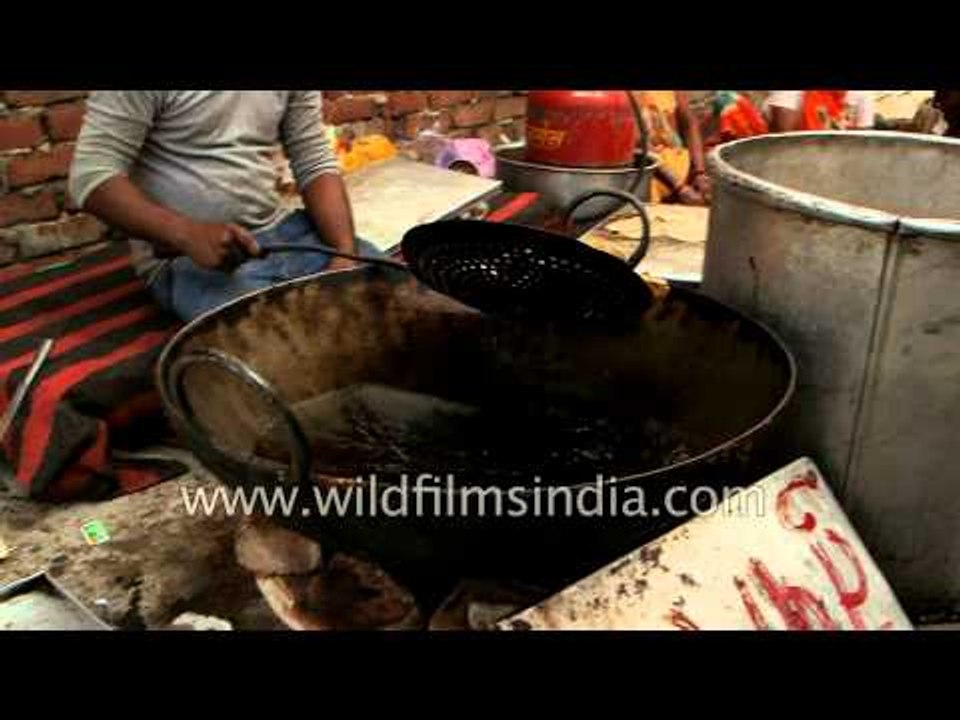 Women kneading wheat dough to make puri in Aligarh