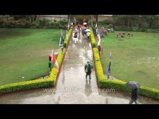 Rainy day in Rishikesh: yoga guests brave rain with umbrellas