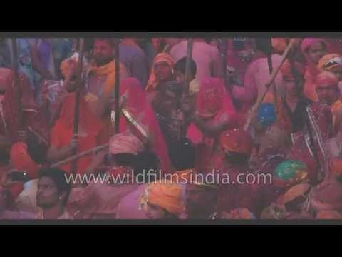Women beat men with sticks during Lathmar Holi