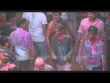 The priest throws colours at participants during Holi celebration - Vrindavan