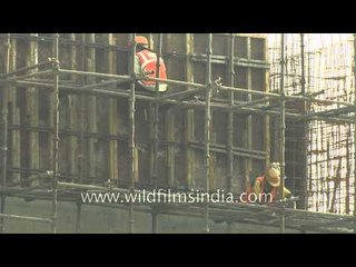 Labourers work at a construction site in Delhi