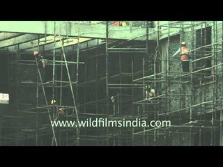 Construction workers work at a site in Delhi