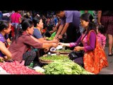 Women buy and sell vegetables at market in Mizoram, India