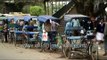 Cycle rickshaws line up alongside Ring Road in Delhi