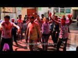 People celebrate Holi on the streets of Vrindavan, India