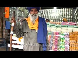 Nihang Sikh pose for camera outside Patalpuri Sahib Gurudwara