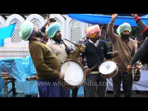 Sikh men plays bagpiper and drums outside Guru Dutta Gurudwara