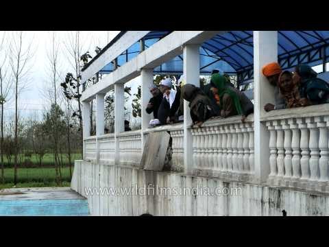 Sikh people immerse ashes of their departed ones in Patal Puri Sahib Gurudwara, Punjab