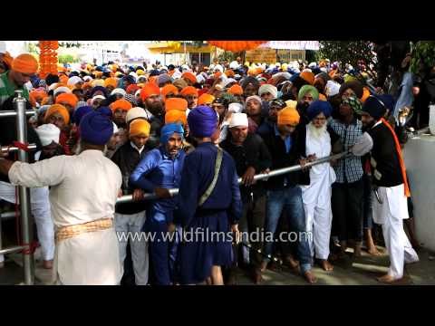 Devotees await their turn to pay obeisance to Sikh Guru at Kesgarh Sahib Gurudwara, Punjab