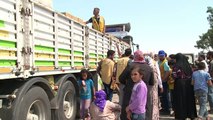 Syrian refugees receive food aid in makeshift Turkish camp
