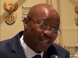 Home Affairs Director-General Mkuseli Apleni briefing the media on