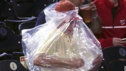 Fan Struggles to Put His Poncho on, Poncho Wins