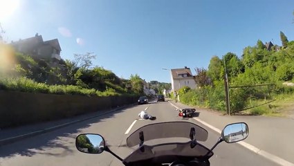 A man on a motorbike chases a reckless driver