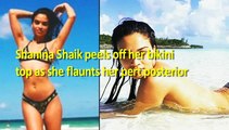 Shanina Shaik peels off her bikini top as she flaunts her pert posterior