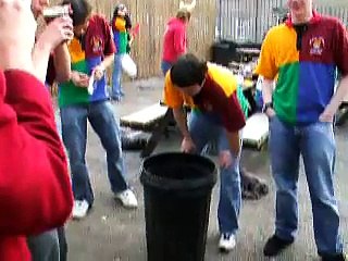 Some people throwing up in a bin.