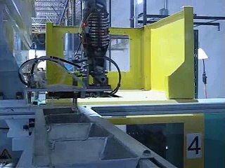 Yushin robot on injection molding press