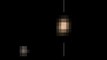 Plutón y su luna Caronte en movimiento y color