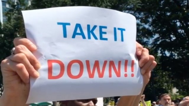 Demonstrators rally against Confederate flag