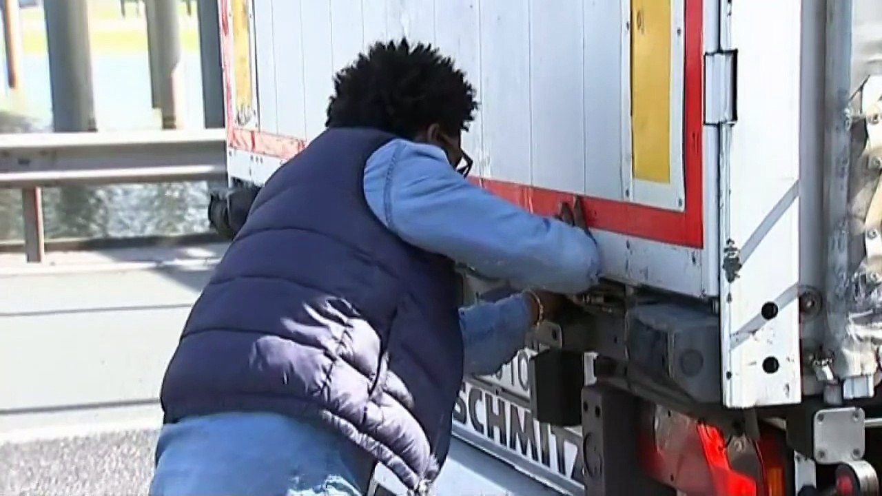 Calais migrant crisis: Moment man climbs into lorry cabin