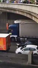 A taxi driver throws a stone from a bridge - the strike of taxi drivers in Paris