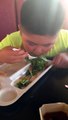Kid eating veggies from his bento box japanese food