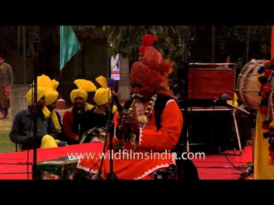 Old man playing a flute in India - Punjab Mela