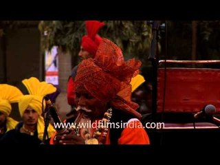 Old man with turban playing a flute in India