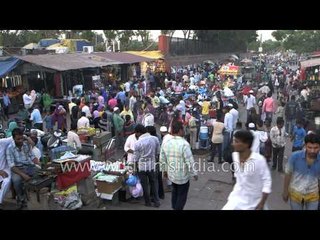 People at a messy street market in Old Delhi