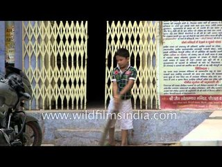 Children play cricket on the streets of Old Delhi