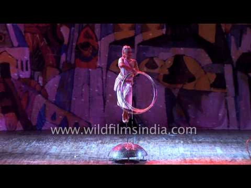 Russian performer spins multiple hula hoops at circus show in India