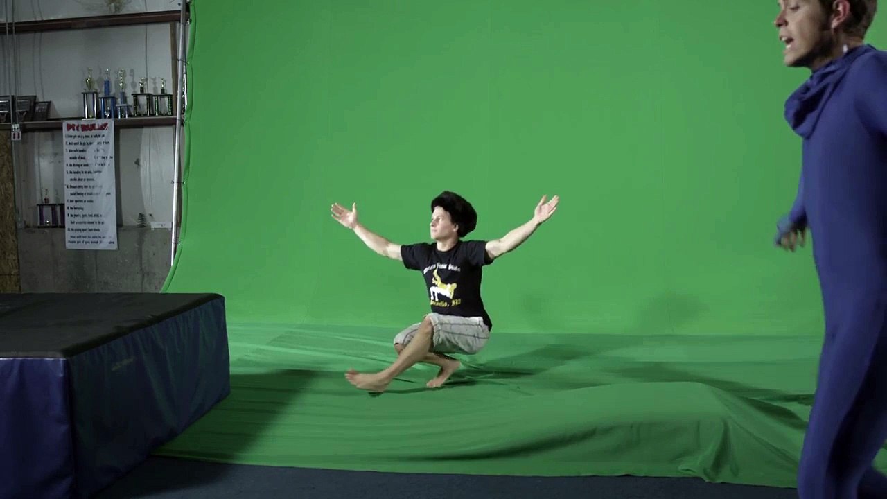 Male in shorts t shirt and Russian hat does a slavic dance