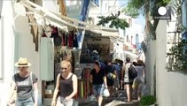 Tourists enjoying Mykonos sun aware of Greek hosts' dark clouds