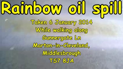 Rainbow oil spill.  Colours refracting from oil on Road