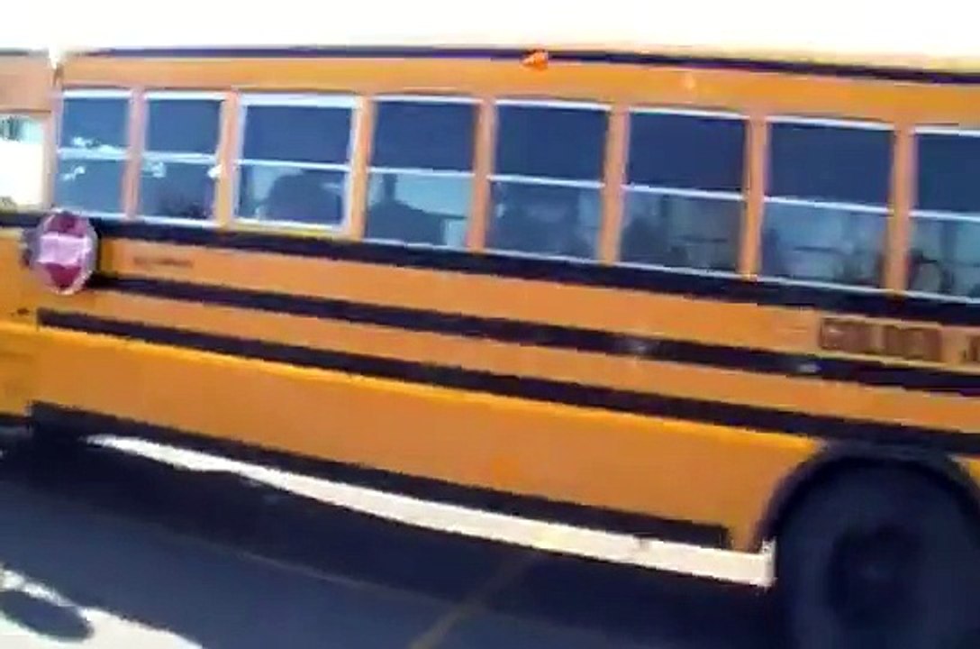 A Blue Bird Golden Arrow School Bus Starting Up and Driving off From Meadow Brook Sobeys Edmonton