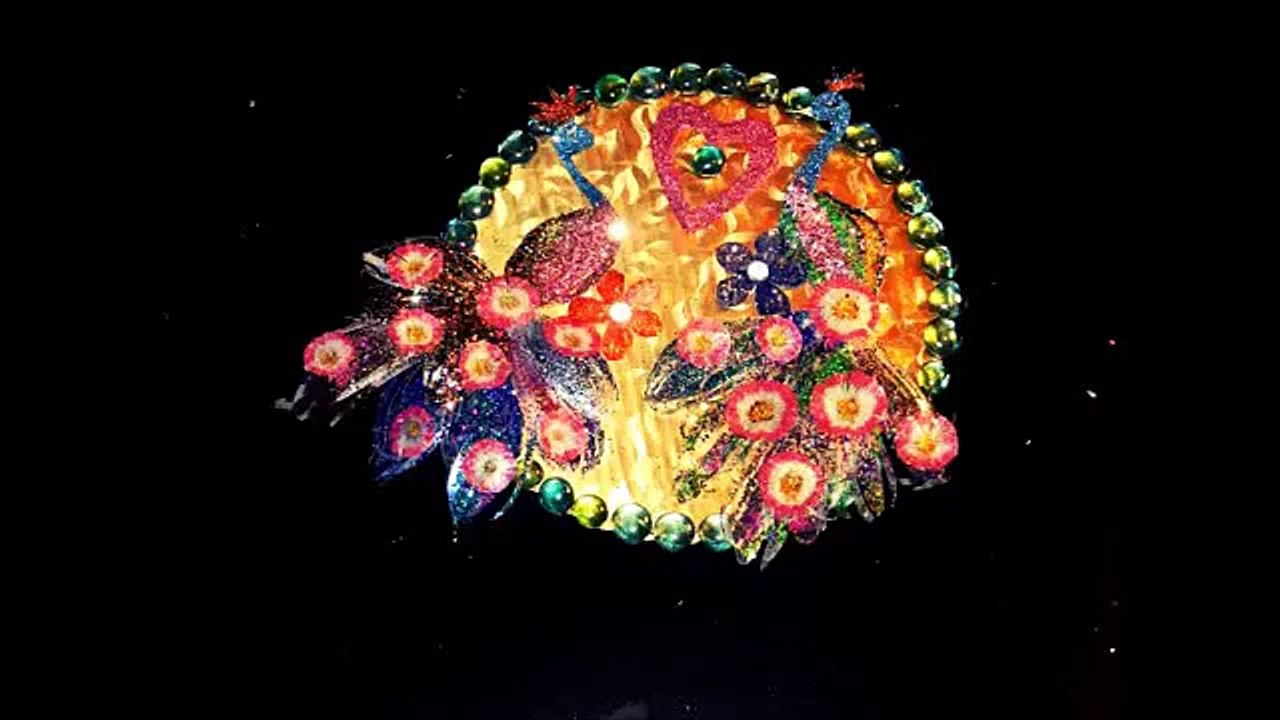 DIY peacock wall hanging made with recycled plastic can