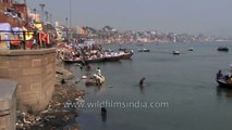 Heavily polluted Ganges river: Washing clothes and bathing in Varanasi