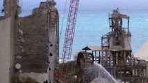 crane smashing into concrete silos