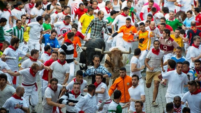 Running from bulls through the streets of Pamplona