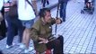 Blind Chinese beggar playing erhu on street