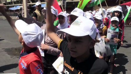 Fighters in military uniforms march in Baghdad for Jerusalem Day